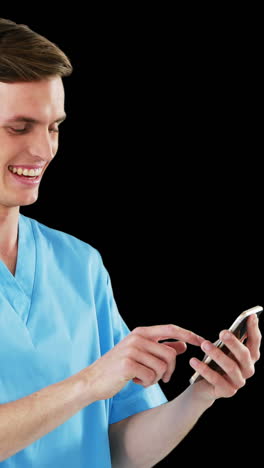 smiling surgeon using mobile phone