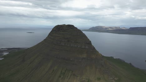 drone flight reveal grundarfjörður fjord behind iconic kirkjufell mountain