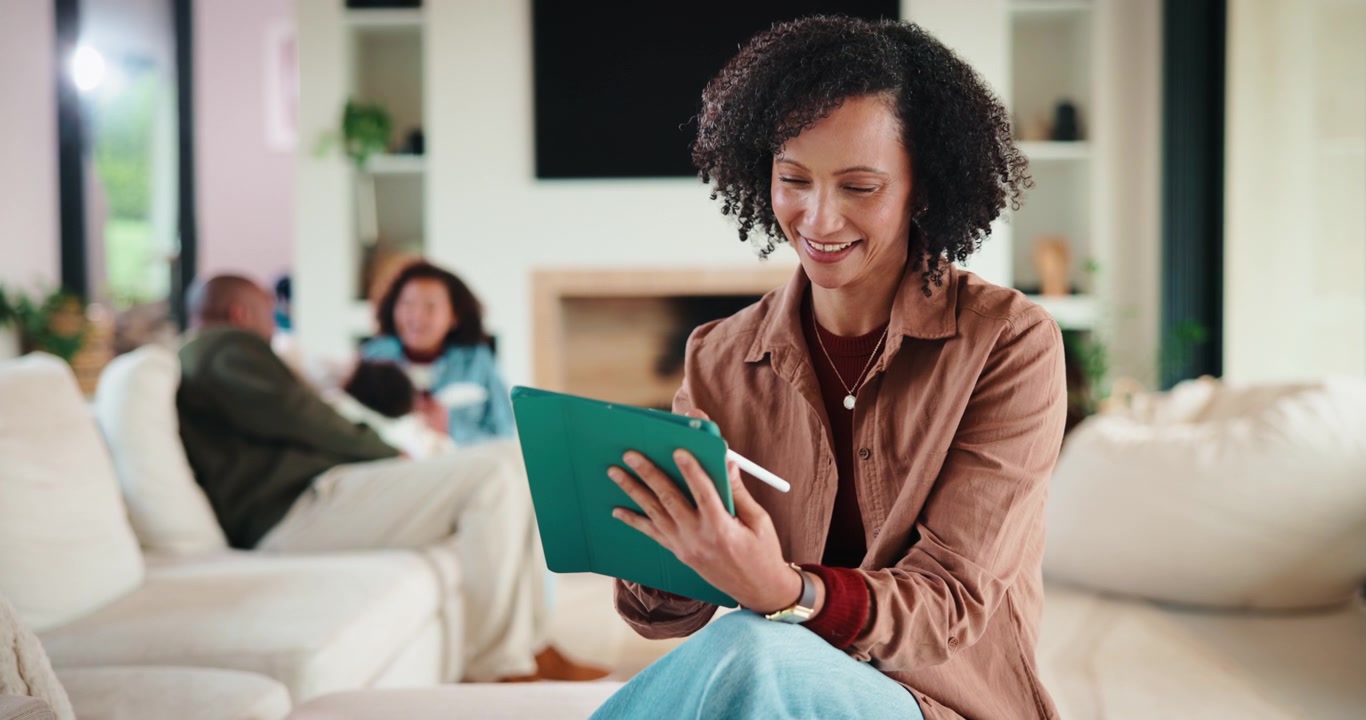 Woman Using Digital Tablet with Stylus in Living Room