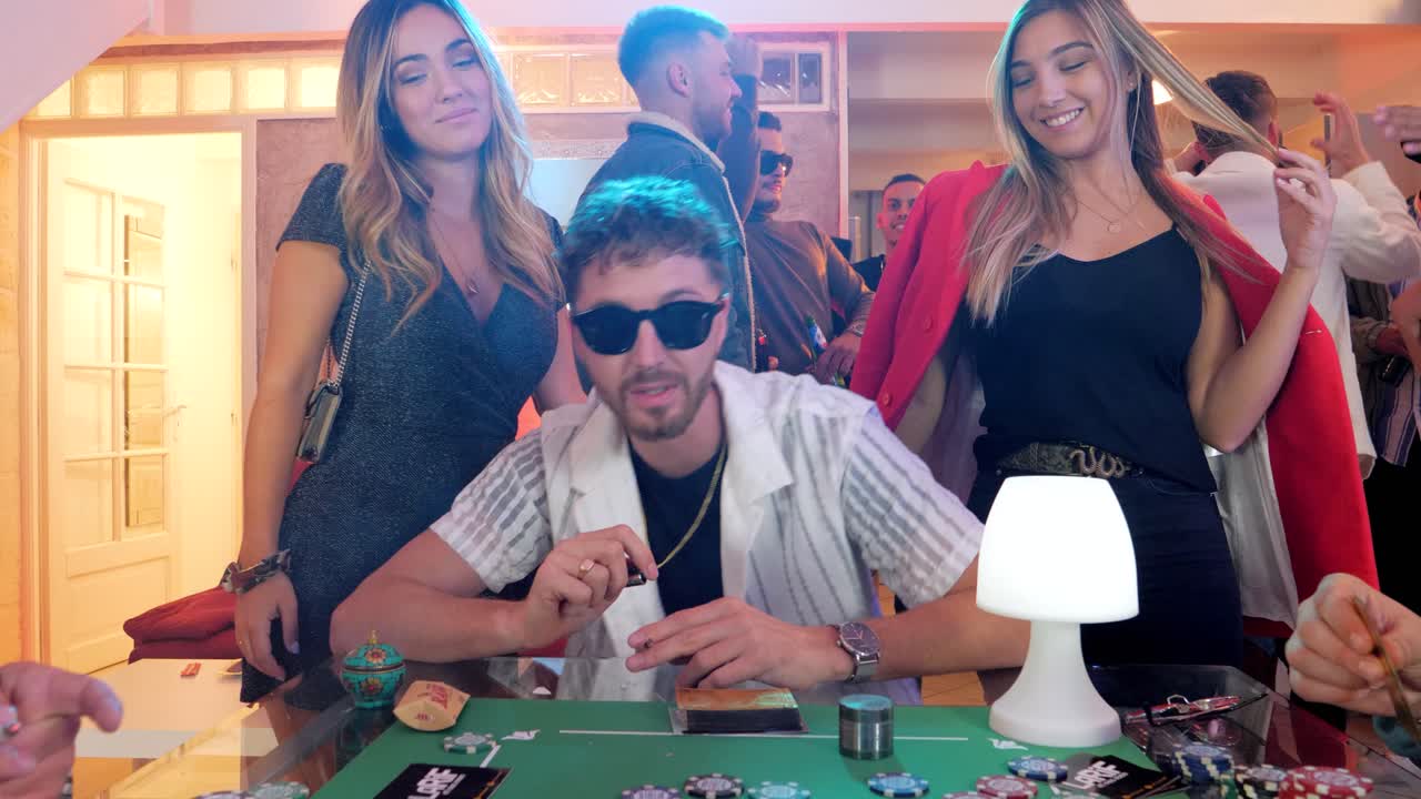 revealing shot of poker players singing and smoking at a house party