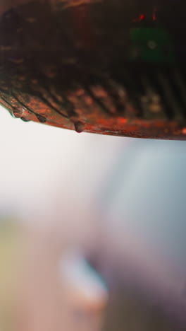 falling drops on car wing mirror under rain closeup. wet automobile at spring rainstorm at countryside. splashing water on vehicle outdoors
