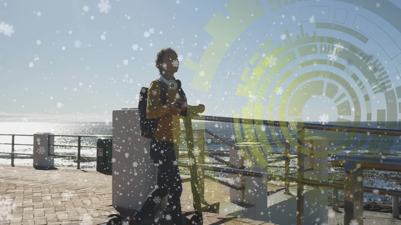 Person walking with backpack over digital interface and snowflakes animation