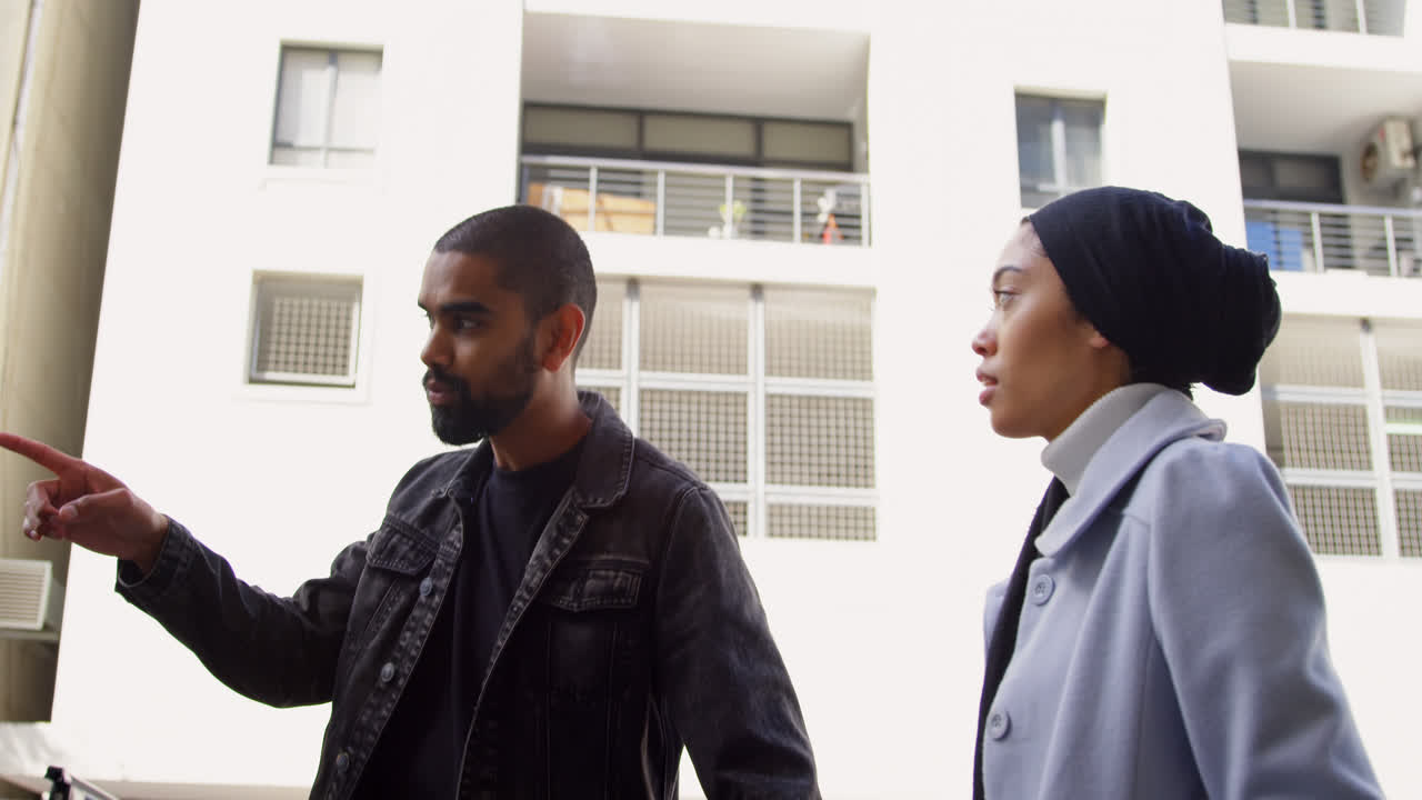 Young couple walking on street 4k