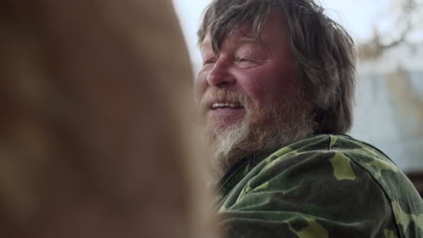 smiling older man in camouflage jacket