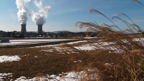 smoke rises from the nuclear power plant at three mile island pennsylvania with farm fields foreground