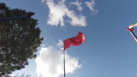 albanian flag waving in the wind, blue sky