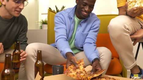 friends enjoying pizza and beer during a casual get-together