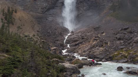 large waterfall takkakaw falls yoho national park british columbia tourists tilt up