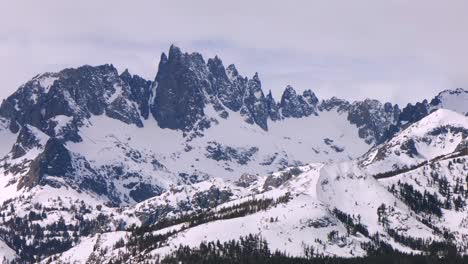 minarets mountain range jagged towering peaks vista point panoramic landscape mammoth mountain ski resort aerial drone california winter spring sunny blue sky morning inyo national forest parallax