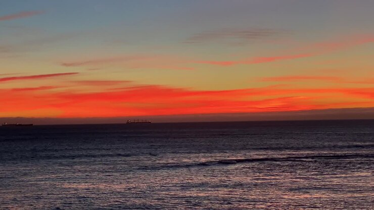 Beautiful natural background ,cloudy orange sky with sunset over blue ocean
