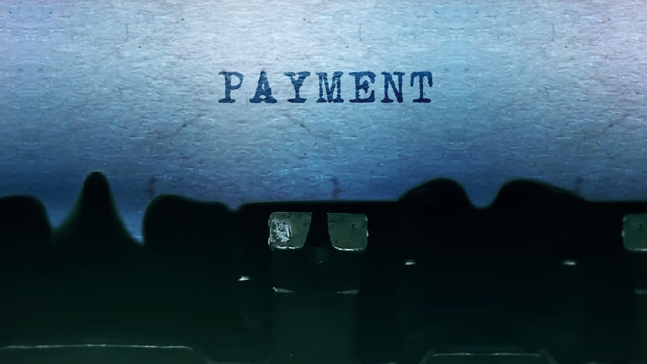 Payment word closeup being typing and centered on a sheet of paper on old vintage typewriter
