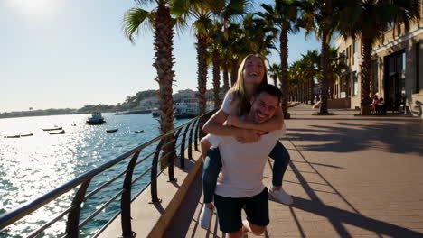 happy couple enjoying a waterfront stroll