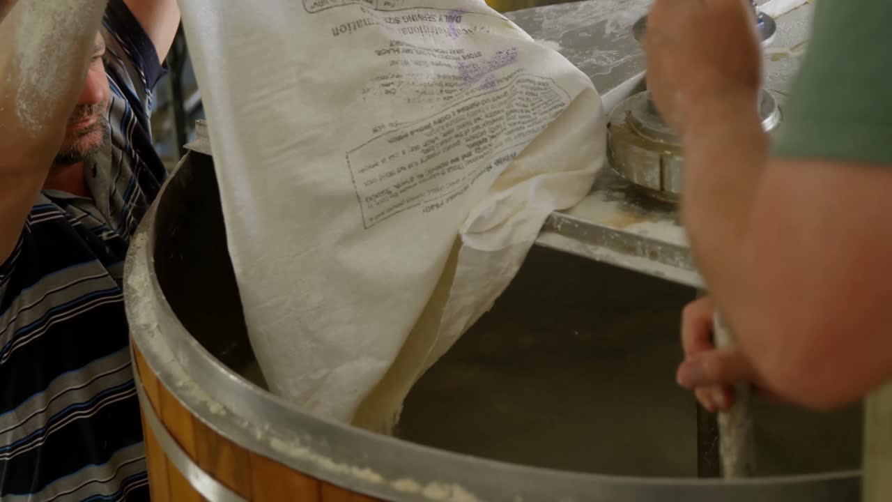 Male workers preparing gin in distillery 4k