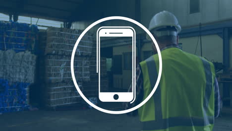 animation of smartphone icon over caucasian male worker in warehouse