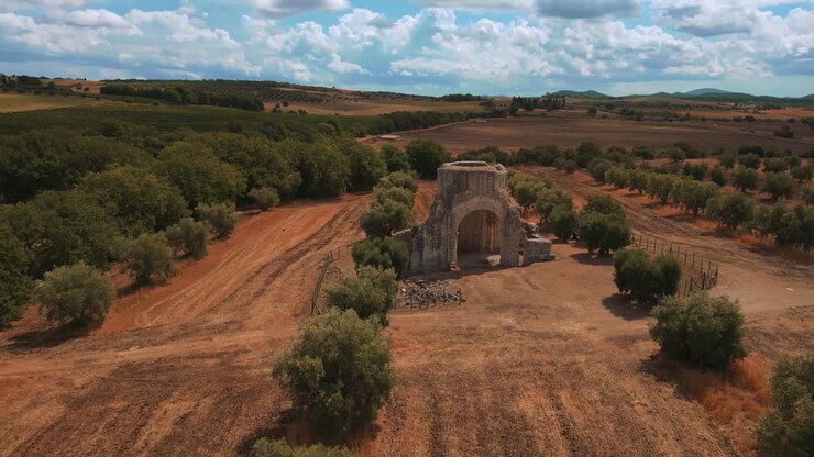 Old medieval church monastery abbey Abbazia di San Bruzio, a damaged abandoned ruin in Tuscany from the 11th century Middle Ages surrounded by olive trees in Italy