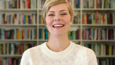 woman smiling in front of library