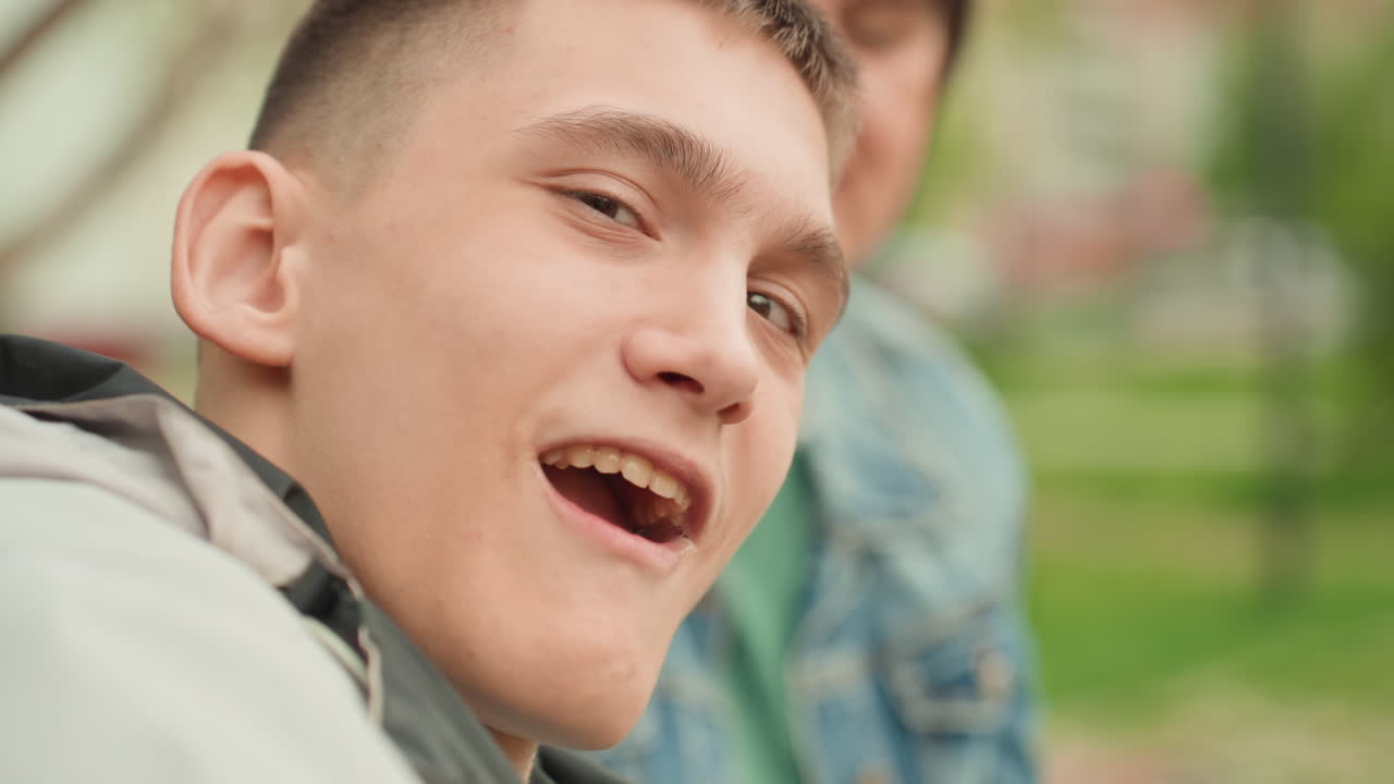 Youthful Singing Session, Teenage Caucasian Male Engaged In Outdoor Music Therapy Activity, Young Caucasian Man Actively Singing During Group Music Therapy Outdoors With Peers And Volunteer
