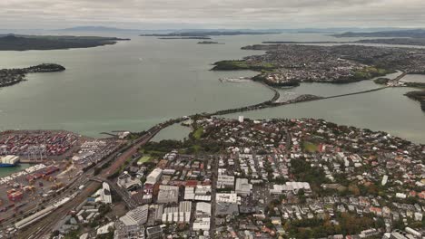 this breathtaking 4k 60fps panoramic drone shot captures the beautiful harmony of auckland, where a modern city skyline meets the sparkling blue waters of the hauraki gulf and green volcanic cones