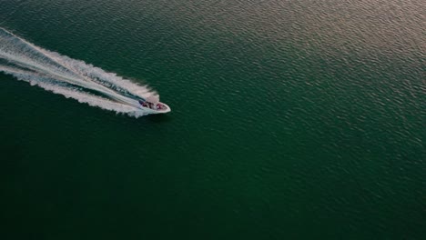 slow motion aerial drone shot over speed boat passing through beautiful blue ocean tropical destination florida traveling to new destinations summer vacation concept 4k