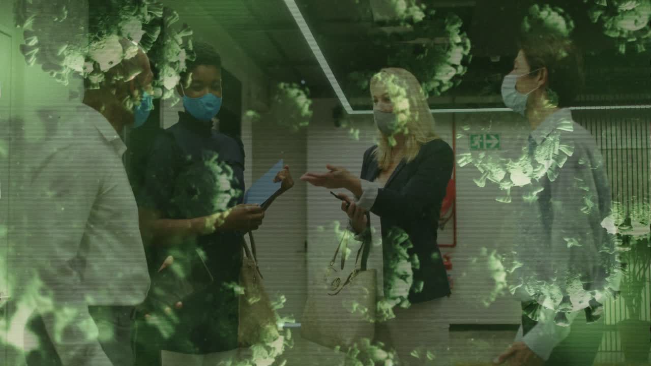 Masked staff reviewing file for work in clinic, woman gesturing while green overlay hiding faces