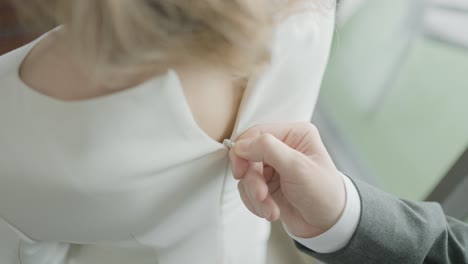 bride getting dressed for wedding