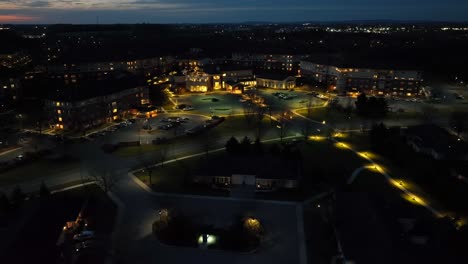 wide aerial establishing shot of large retirement community and home in america at night