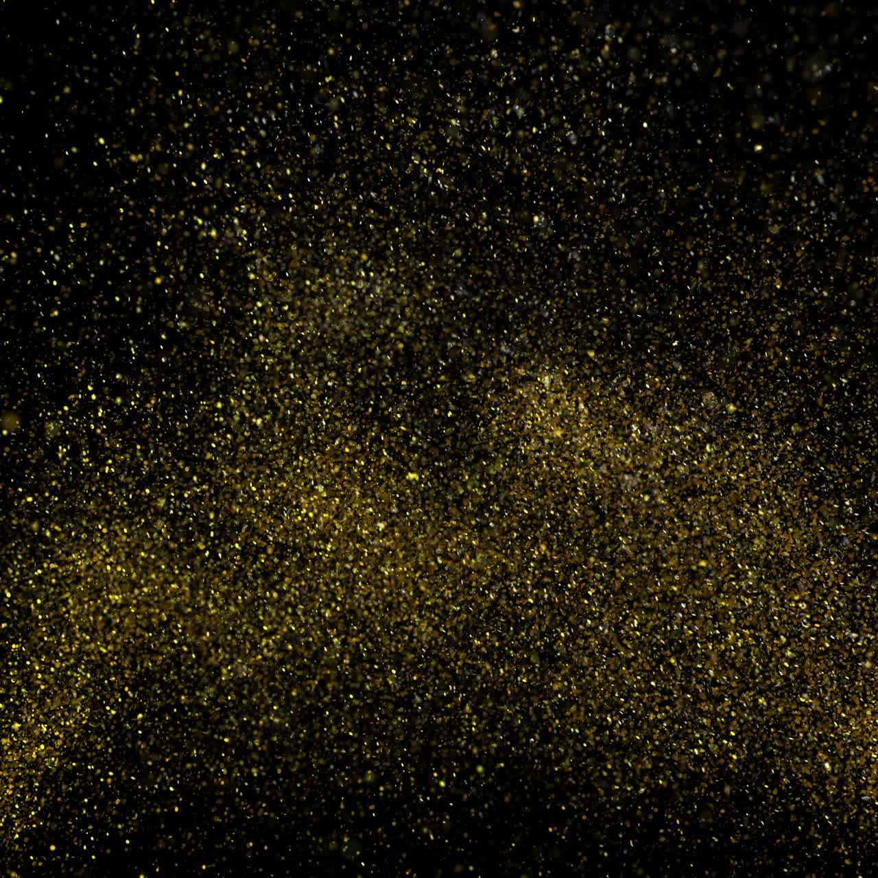 Partículas de Glitter Dourado Explodindo e se Espalhando em Fundo Preto
