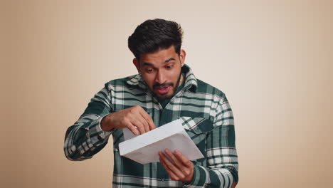 indian man open envelope letter great news celebrate monetary award invitation bank loan approve