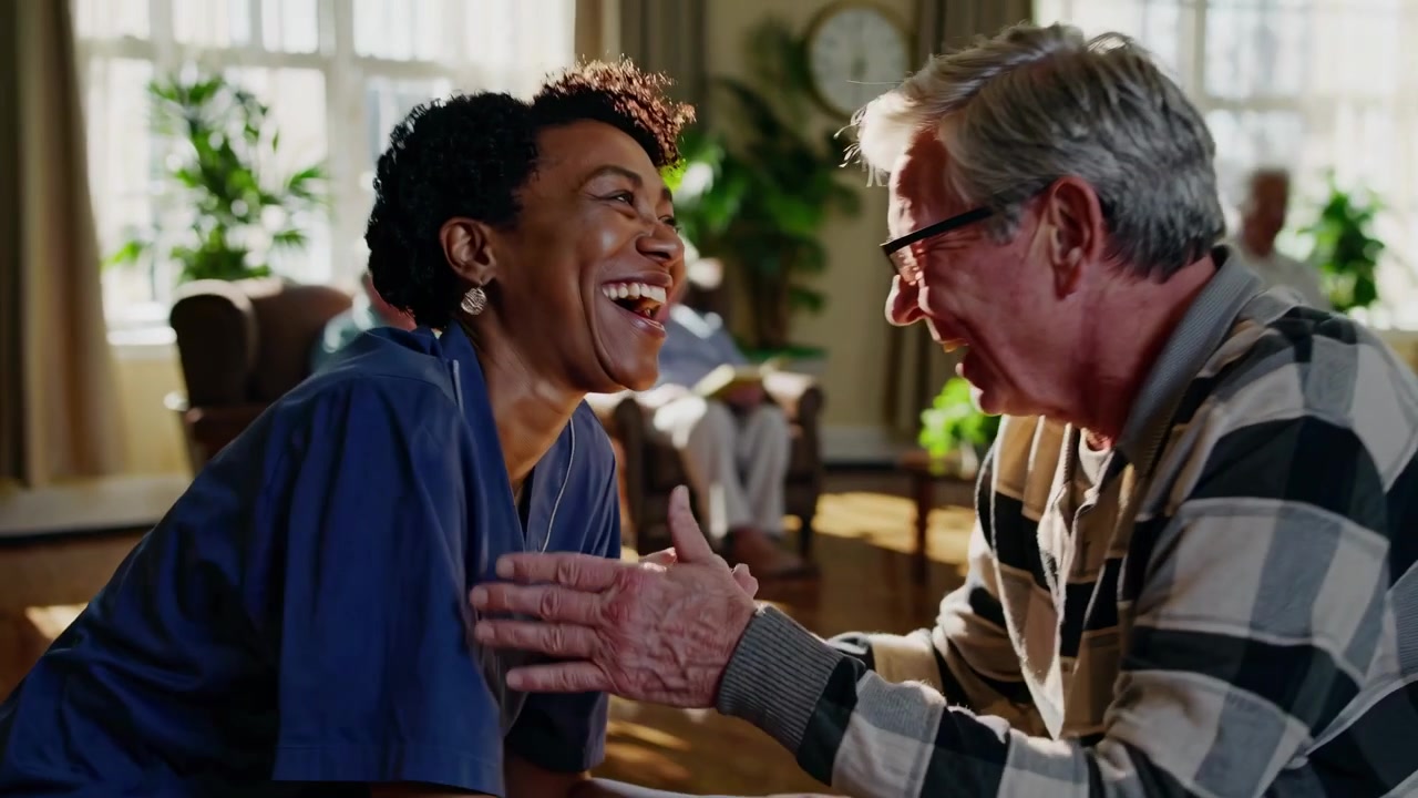 Caregiver Laughing and Bonding with Senior Man in Assisted Living Facility