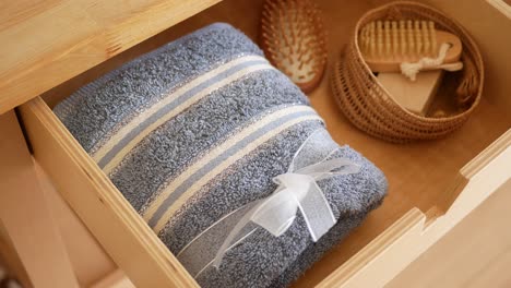 wooden drawer with towels and accessories