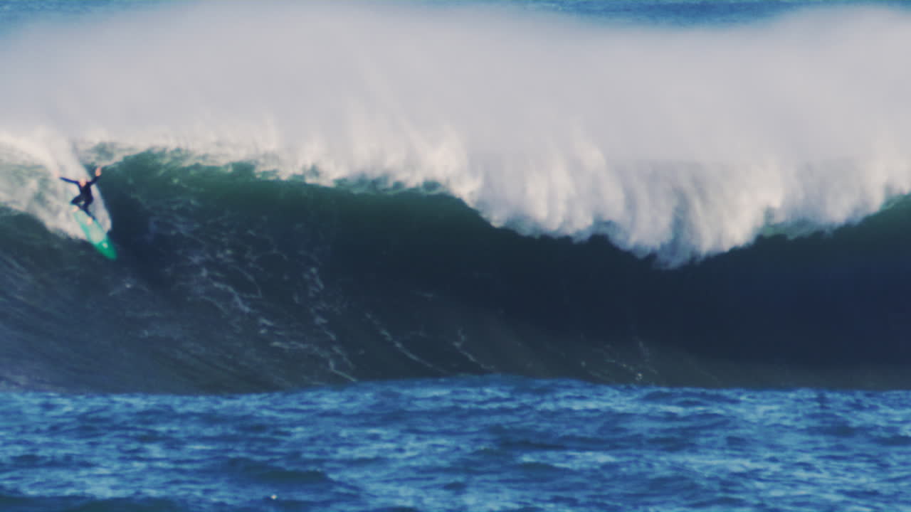 Turbulent ocean waves crashing over Sydney's rocky shore, with powerful surf and misty air swirling.
