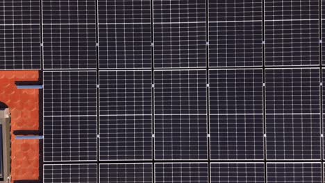 top down view of solar photovoltaic panel system on roof - drone shot