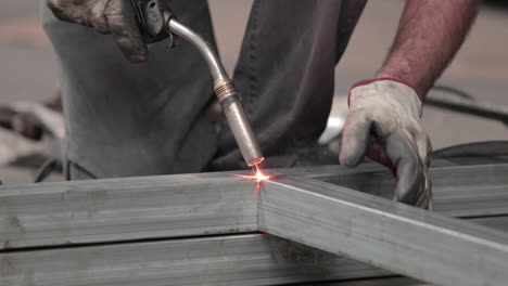 welding sparks as a worker welds metal frame - close up