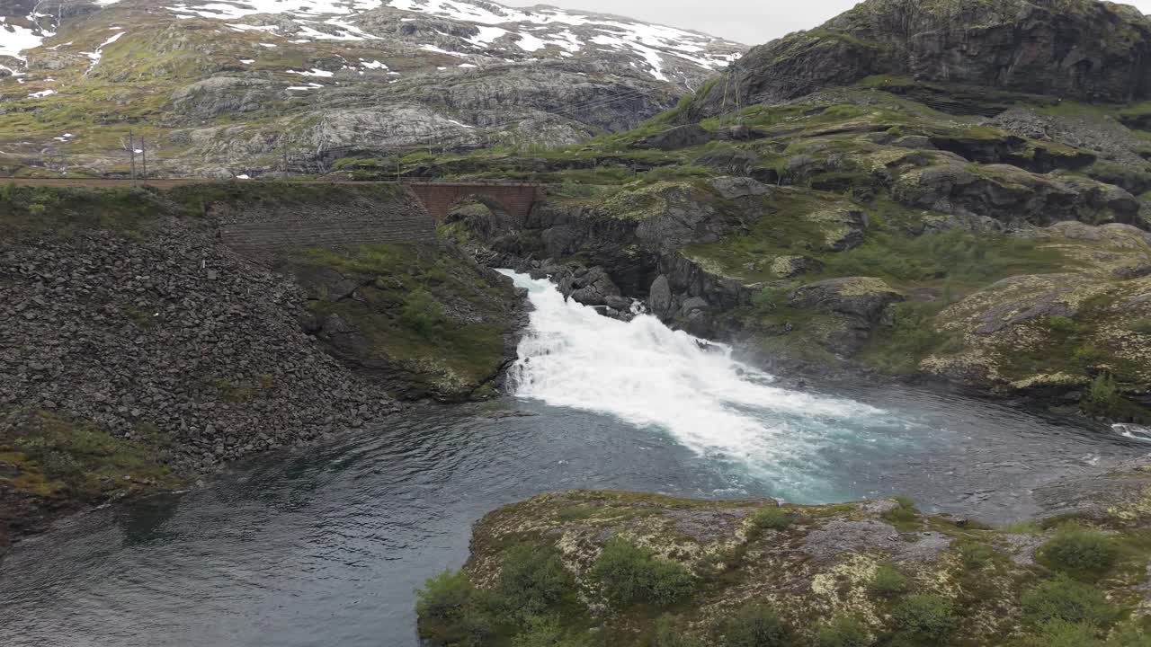 Klevagjelsbrua Bridge Along The Rallarveien Route With The Stigfossen Waterfall In Norway. Aerial Orbiting Shot