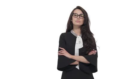 Young Caucasian business woman in glasses appearing on white background. Strong face, crossed arms