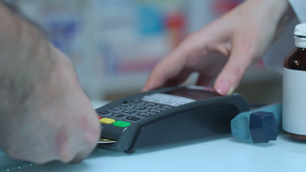Male hand enter password on pos terminal at drugstore. Credit card payment