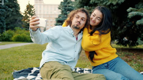 couple taking selfie in park