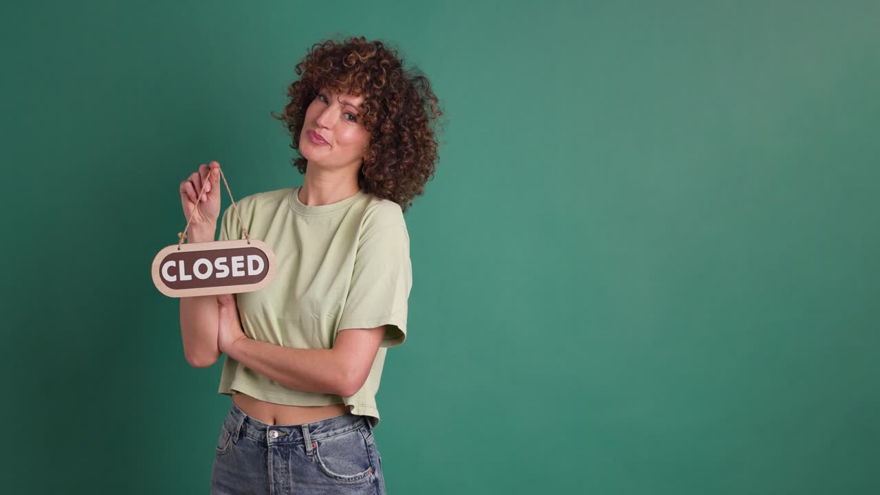 woman with closed sign on green background