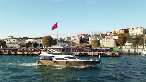 Yate-En-El-Estrecho-Del-Bósforo-En-Estambul-Con-Bandera-Turca-En-Segundo-Plano.