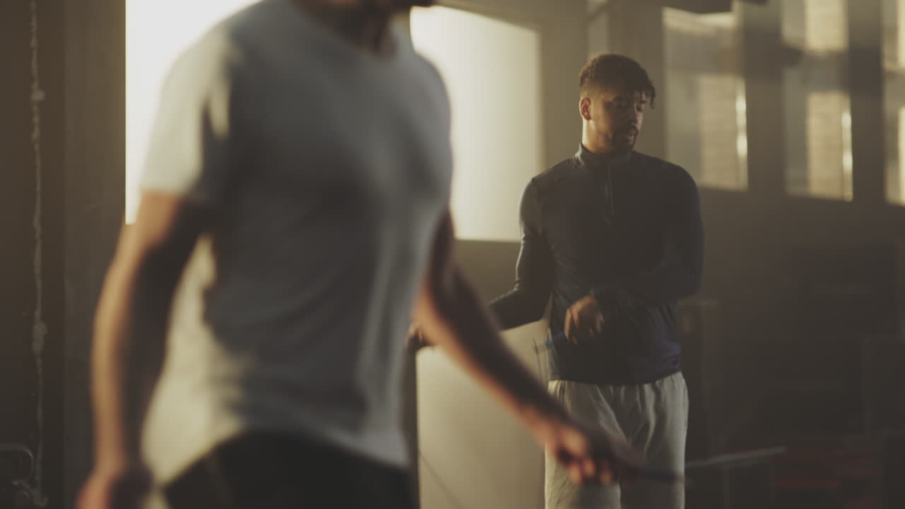 hombres saltando la cuerda en el gimnasio