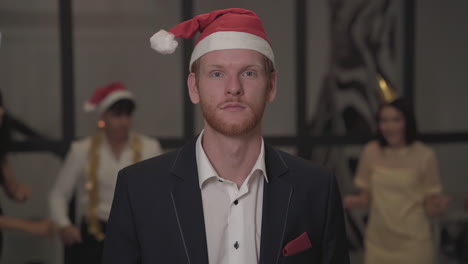 excited young red-haired man celebrating and looking at the camera