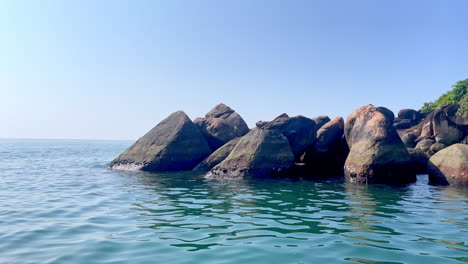 calm waves in ocean hitting rocks goa india 4k