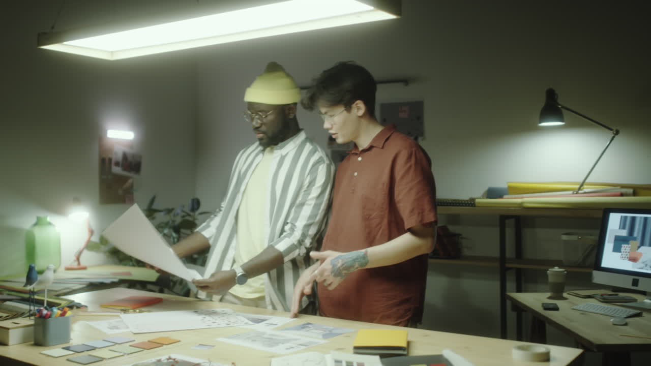 Two Designers Collaborating on a Project in a Creative Studio