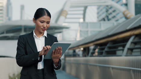 businesswoman using a tablet in a city