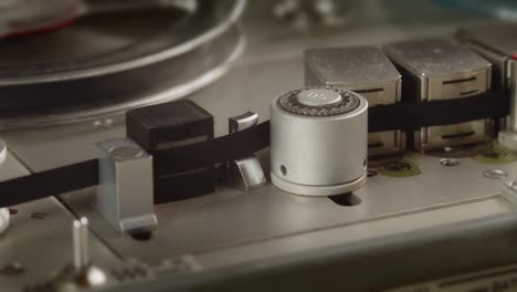 Close-up-of-tape-rolling-in-Nagra-old-professional-tape-recorder