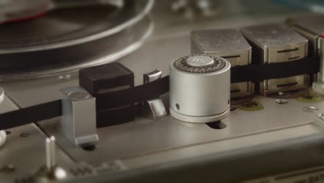 close up of tape rolling in nagra old professional tape recorder