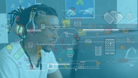 Animation of social icons and data processing over businessman at desk using computer