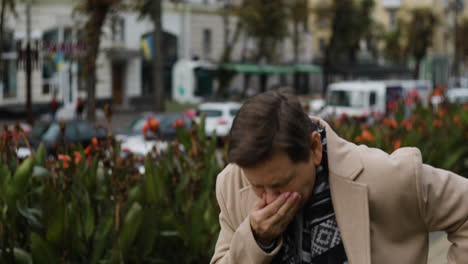 woman sneezing in the middle of the street