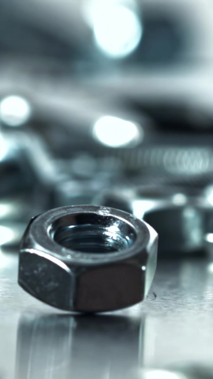 Macro Shot of a Metal Nut Rotating on a Reflective Surface