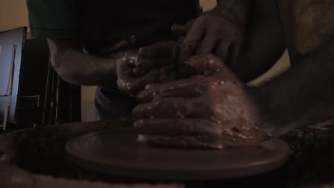 Pottery-workshop,-Close-up-of-hands-clay-throwing-on-pottery-wheel